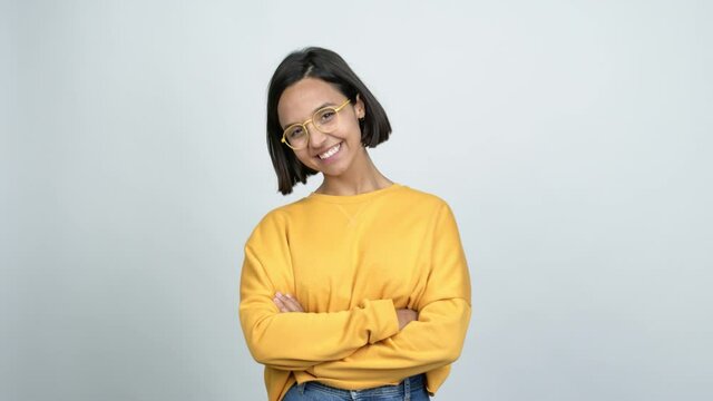 Young latin woman with glasses smiling over isolated background