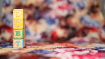 alphabetical letters placed on colored wooden cubes forming the word LGBTQ