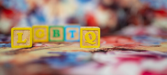 alphabetical letters placed on colored wooden cubes forming the word LGBTQ