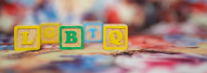 alphabetical letters placed on colored wooden cubes forming the word LGBTQ