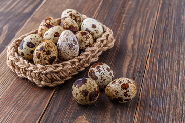 Quail eggs on the wooden plate. Quail eggs can be consumed by frying or boiling. In Indonesia quail eggs called telur puyuh.