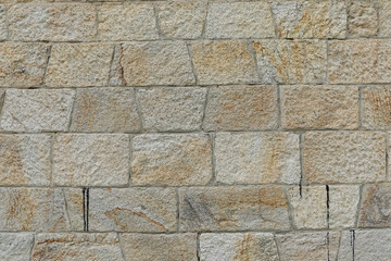 New  and even brick wall with structure of white, grey and brown stones, stones background with space for text