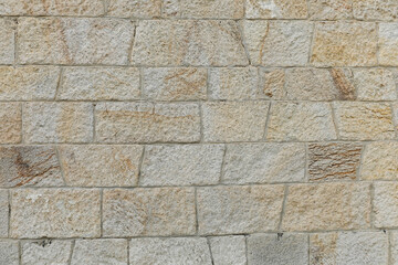Beautiful new stone wall with structure of bright bricks, stones background  empty with space for text