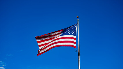 USA Flag waving in the blue sky