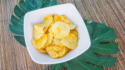 Chips on a wricker table. Space for text or design. Top view.
