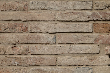 Old brick wall with structure of white, grey and brown stones, stones background with space for text