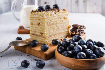 puff cake with blueberries and milk on a white table