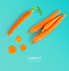 Creative layout made of carrot on the turquoise background. Flat lay. Food concept.
