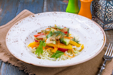Green vegetable salad on blue wooden table