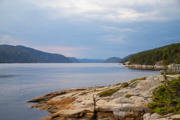 Fototapeta na wymiar Beautiful view on Saguenay river from the rocky shore. Tadoussac, Quebec, Canada. 