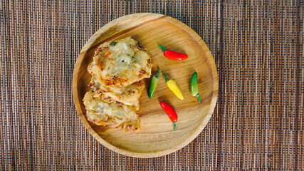Traditional Indonesian snack, Bakwan Sayur is created with okra, carrot, leeks and shrimp as a topping. served with chili