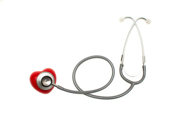 Closeup of old grey stethoscope with red heart isolated on white background . Healthy lifestyle concept. Heart cheking.