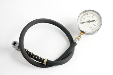 Pressure gauge for measuring air pressure in car tires on a white background