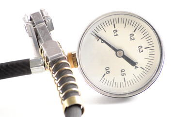 Pressure gauge for measuring air pressure in car tires on a white background