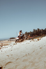 Fototapeta na wymiar biker climbing the dune of paracuru
