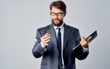 Business man with a coin in his hand on a gray background currency rates finance