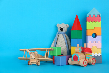 Set of different toys on blue background. Space for text