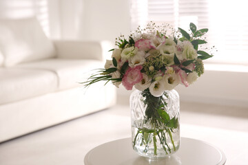 Bouquet of beautiful flowers on table in living room. Interior design