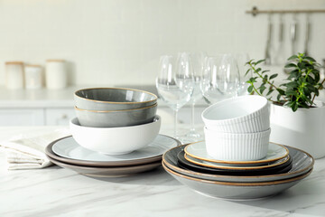 Set of beautiful tableware on white table in kitchen