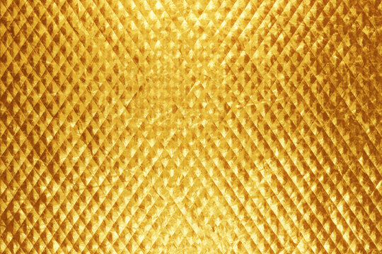 Luxurious gold background with padded diamond shapes.