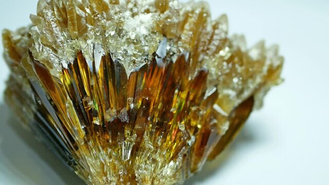 Panning view of the golden yellow calcite isolated on the white background