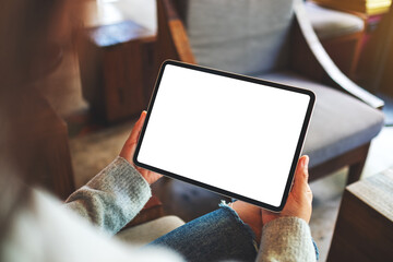 Mockup image of a woman holding digital tablet with blank white desktop screen