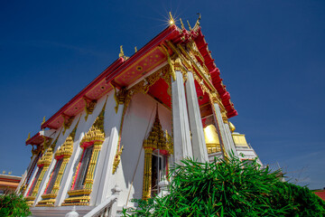 Background of important religious attractions (Wat Hong Thong), a large pagoda on the water, people...