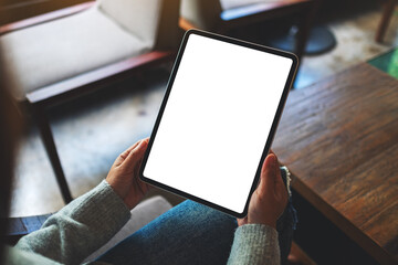 Mockup image of a woman holding digital tablet with blank white desktop screen