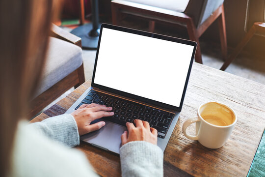 Mockup image of a woman using and typing on laptop computer keyboard with blank white desktop screen