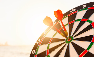 Dart arrow hitting to center on bullseye (bull's-eye) dartboard is the target of purpose challenge...