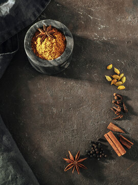 Garam masala and ingredients, vertical, top view