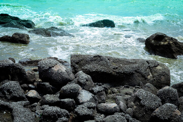 Waves on the seaside rocks are splashing on the rocks