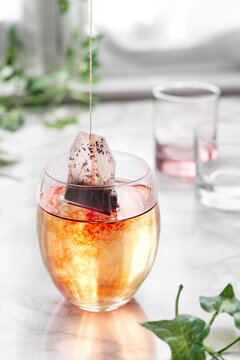 Glass of hot water with steeping tea bag