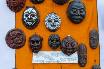 Wooden masks or tribal masks, wall hanging handicrafts, made from wood dusts, on display during the Handicraft Fair in Kolkata - the biggest handicrafts fair in Asia.