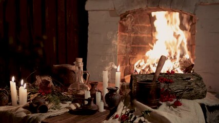 Preparation of items for witchcraft. Burning candles on the background of an open fire in the fireplace, dripping wax. Clay pots with components of poison. Concept of mysticism. - Powered by Adobe