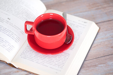 Open a cup of black tea on a book