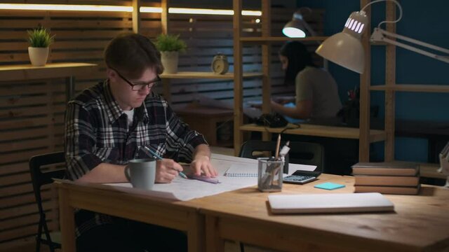 Creative Business Team, Business Project, Hipster Businessmen, Remote Work, Freelance Working. Male designer working on a drawing in a loft office