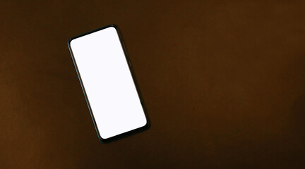 A white screen smartphone on a dark background is a space to create ideas.