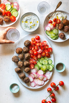 Vegetarian meatballs with tzatziki sauce and vegetables on the plate