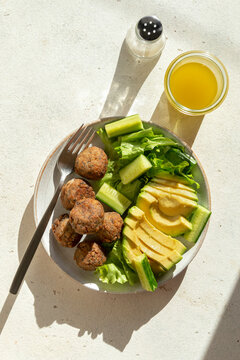 Vegetarian meatballs with lettuce,cucumber and avocado salad in a bowl