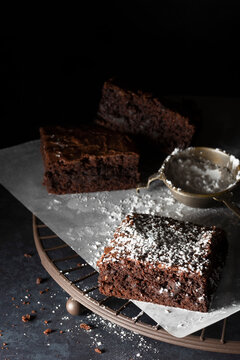 Chocolate brownies dusted with icing sugar.