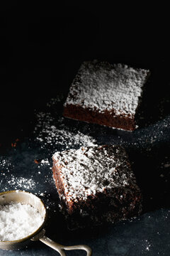 Chocolate brownies dusted with icing sugar.