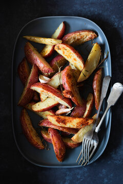 Roasted  potato wedges on a serving dish.