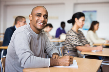 Small group of students attentively listening to lecture in classroom