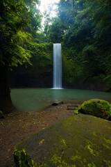 Waterfall landscape. Beautiful hidden waterfall in tropical rainforest. Nature background. Slow shutter speed, motion photography. Tibumana waterfall, Bali, Indonesia