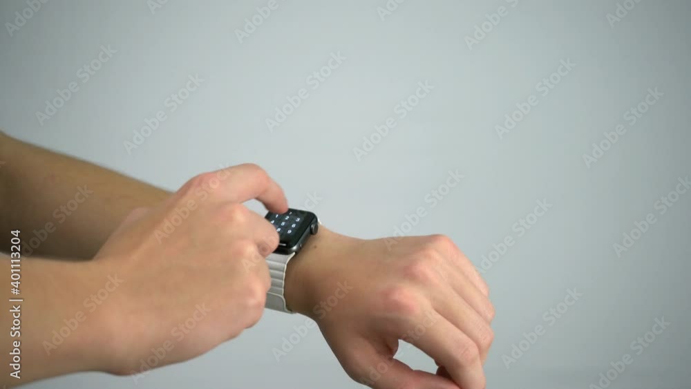Aufkleber Checking time on smartwatch and unlocking with passcode Apple Watch with white studio background shot