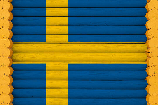 National Flag  Of Sweden On A Wooden Wall Background. The Concept Of National Pride And A Symbol Of The Country. Flags Painted On A House