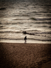 Fototapeta na wymiar Man walking on cold Beach 
