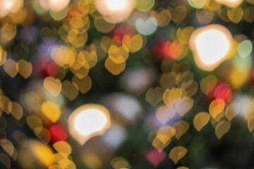Fototapeta premium Blurred bokeh background created by the Christmas lights to celebrate the New Year. Beautiful Christmas lights backgrounds and backdrop can be used for any design Or a Christmas greeting card.
