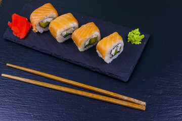 Sushi rolls Philadelphia on a black slate